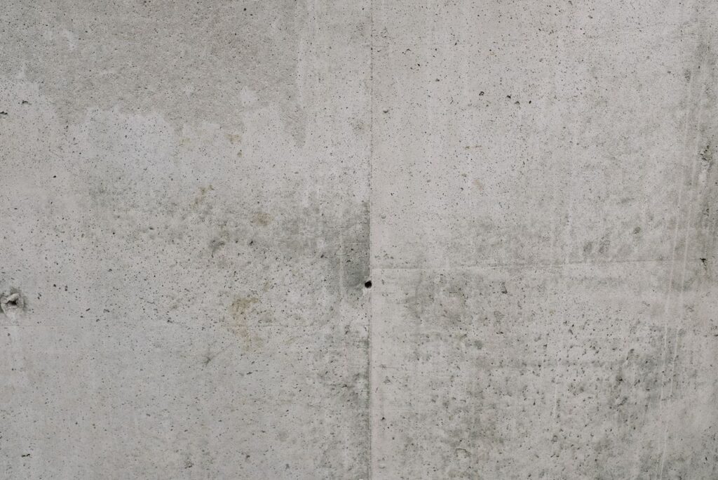 Close-up view of a rough textured concrete wall, ideal for backgrounds.